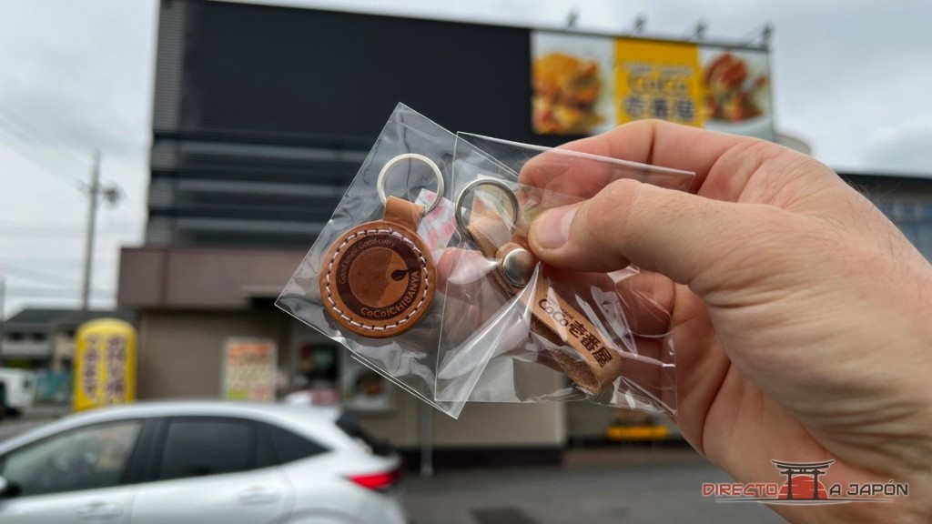 Dos llaveros de CoCo Ichibanya delante de la fachada de Nishibiwajima
